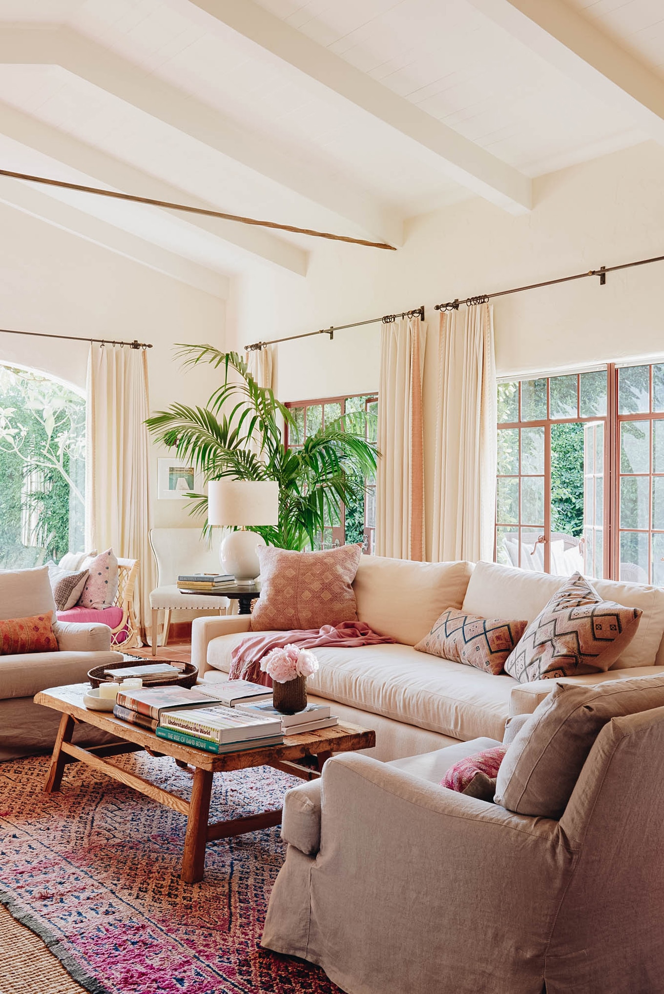 living room with pink moroccan rug and textiles with california hacienda style | coco kelley