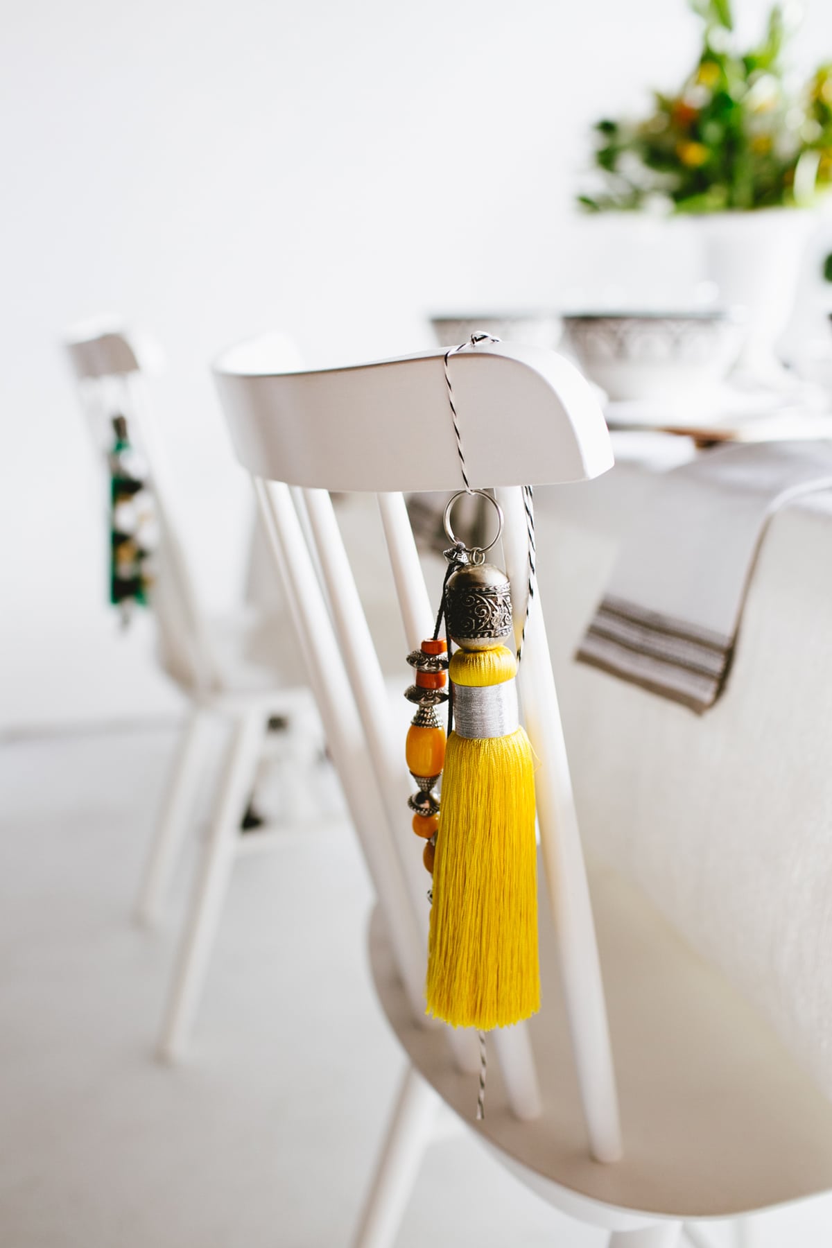 hang moroccan tassels from guest's chairs for a simple gift | moroccan tabletop by coco kelley