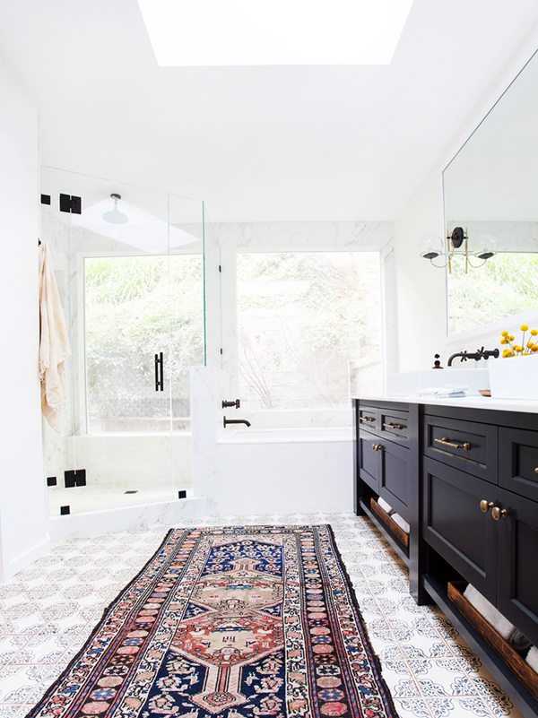 white bath with moroccan tiles and black fixtures and vanity // amber interiors