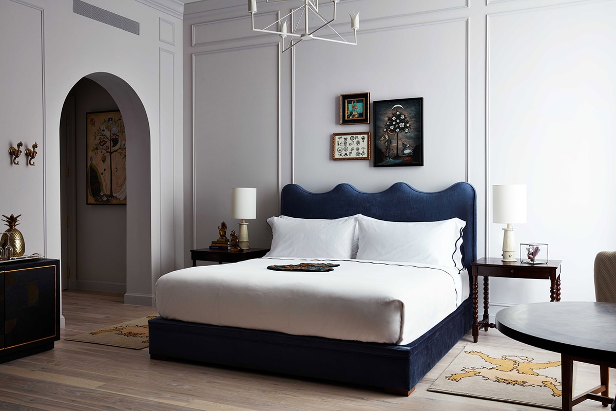 the bedroom suites at maison de la luz with lilac walls and a royal blue bed | coco kelley