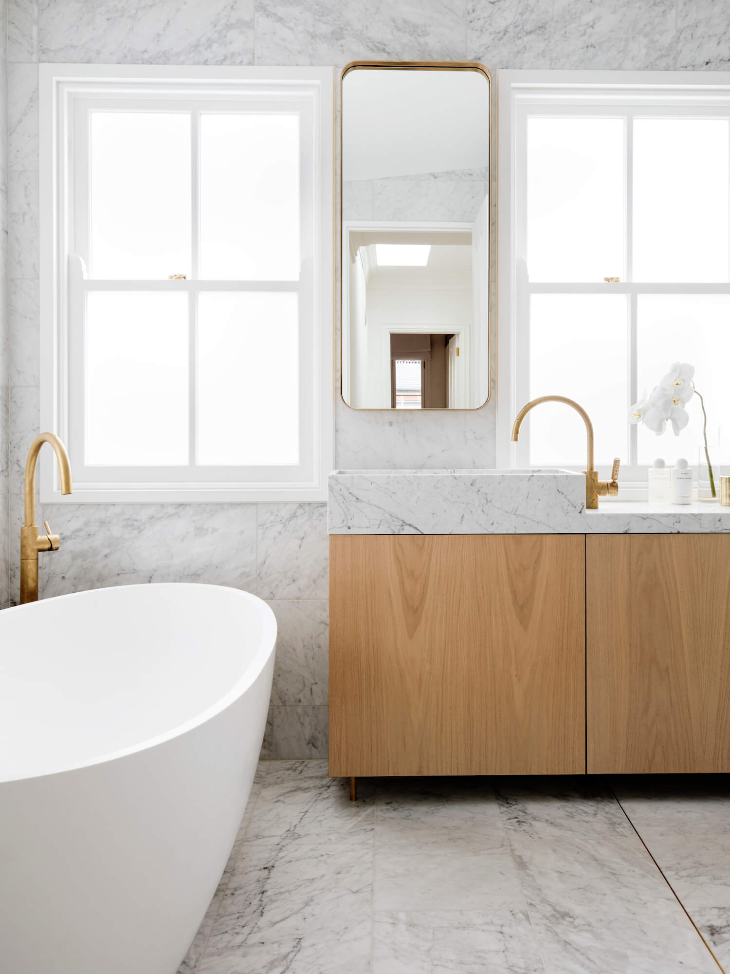 marble bathroom with brass detail and oak vanity | house tour on coco kelley