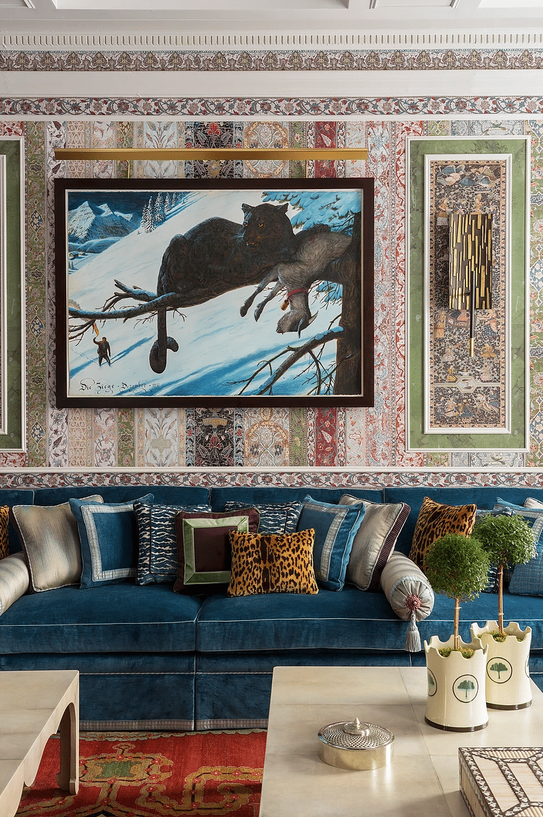 maximalist living room featuring layers of wild pattern and animal print with a blue velvet sofa | coco kelley room of the week