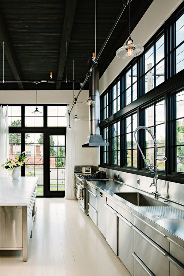 modern clean industrial style kitchen with black walls and marble counters