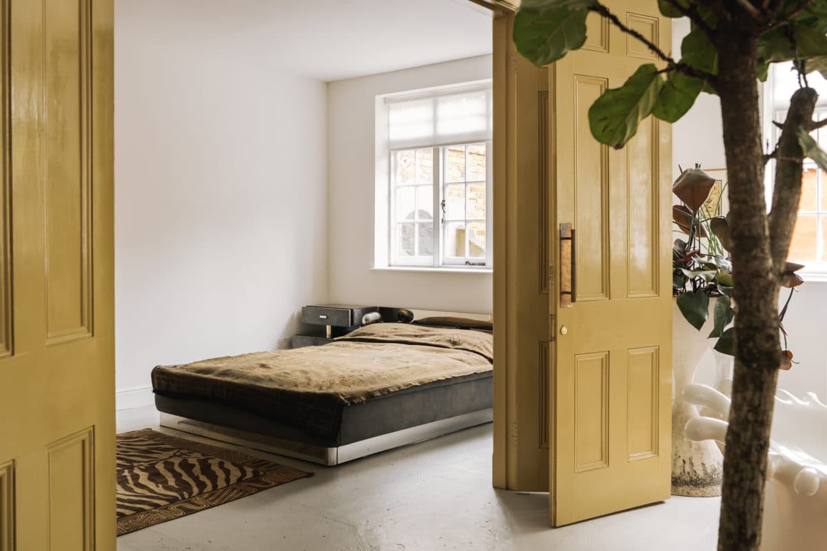 mustard ochre yellow doors and simple loft style bedroom with 70s style - cyndia harvey