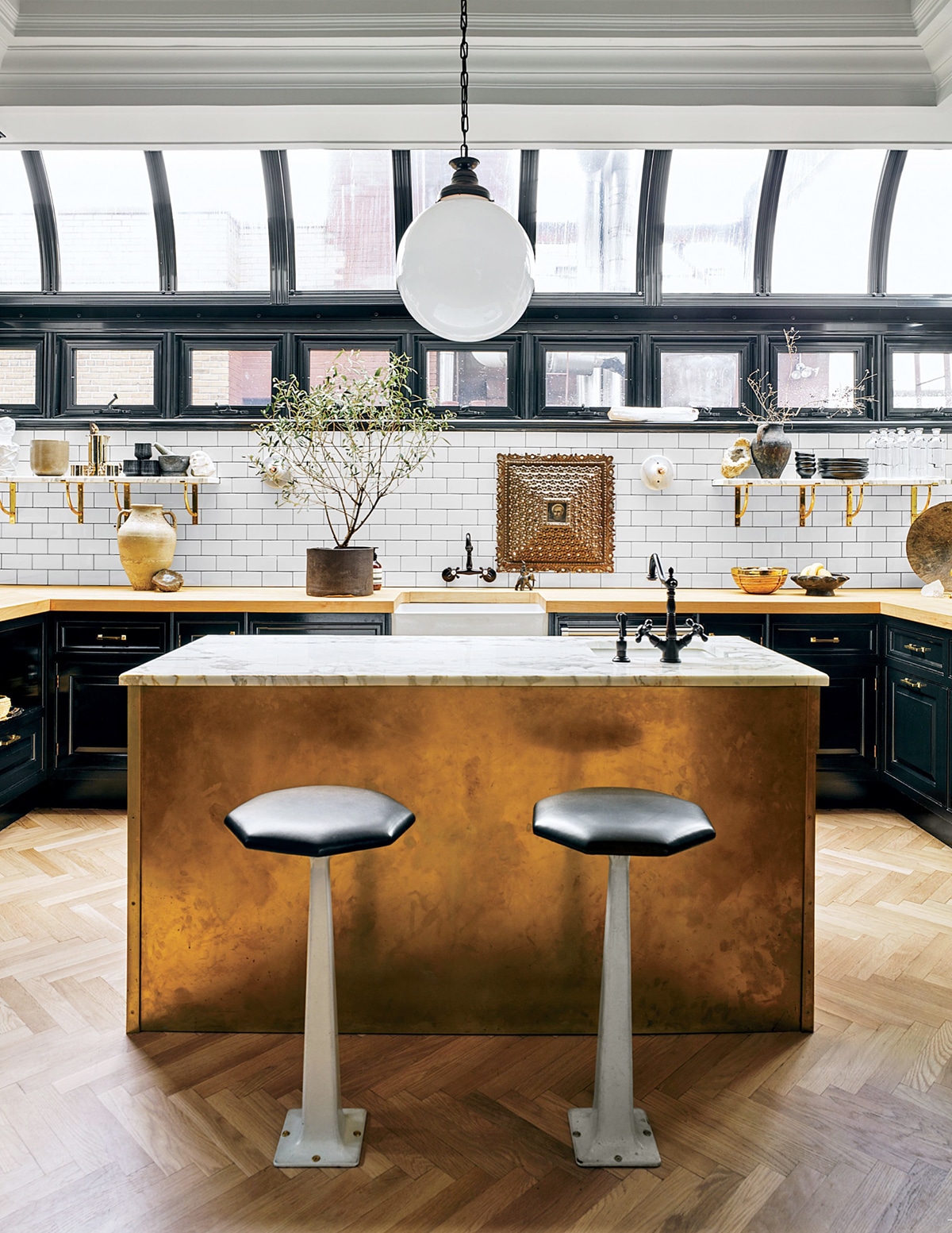 nate berkus' stunning kitchen with brass island and huge windows