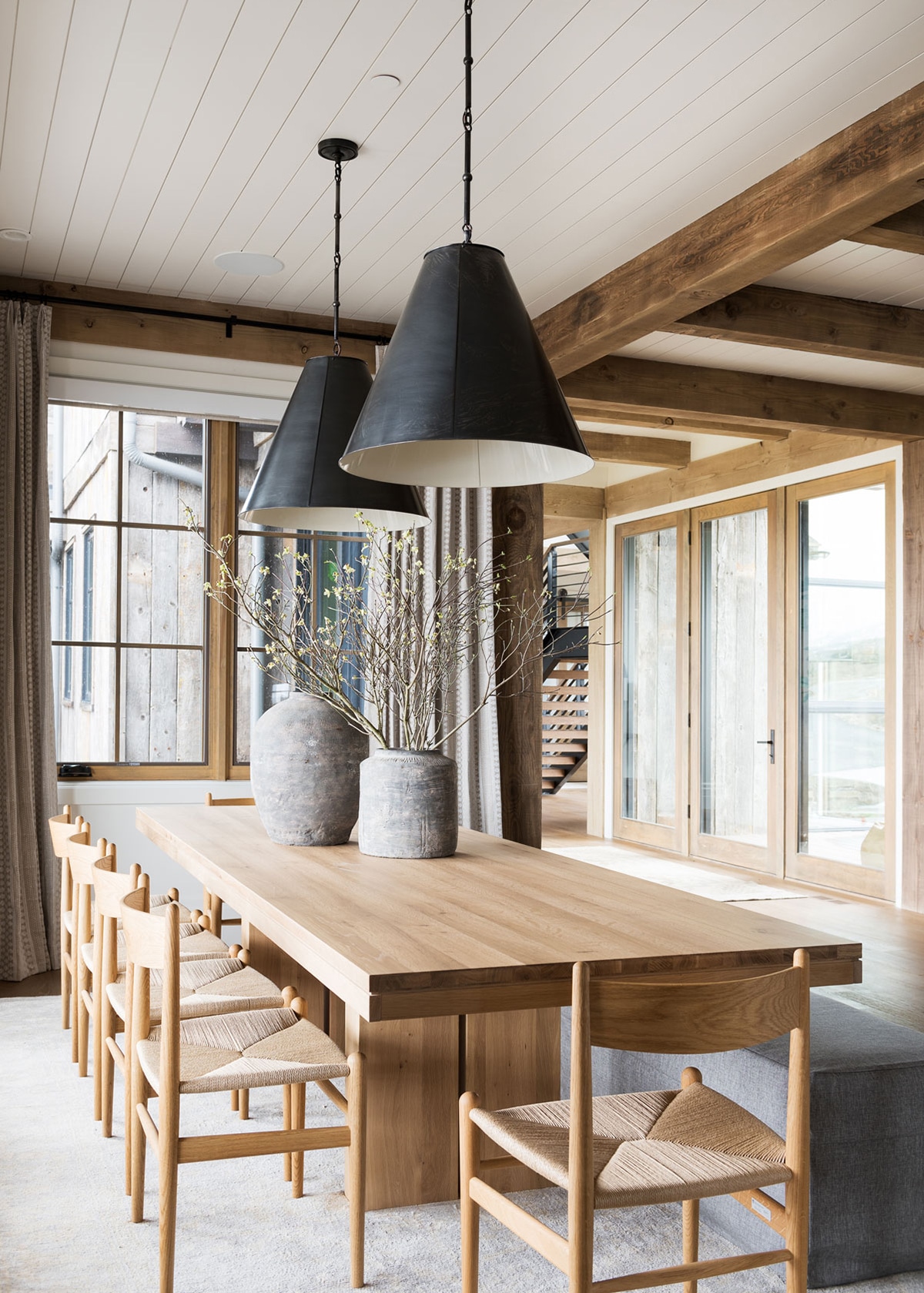 oak dining table and chairs with oversized black pendants | studio mcgee