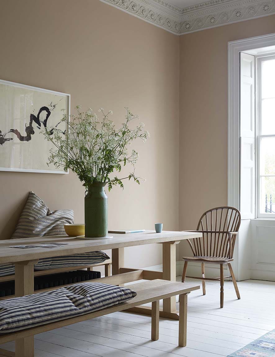 pale peachy pink walls and a modern english dining room