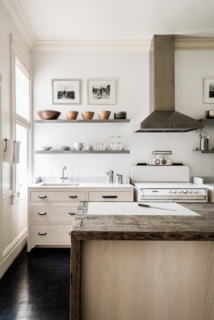 pale wood cabinets and reclaimed wood island | via coco kelley