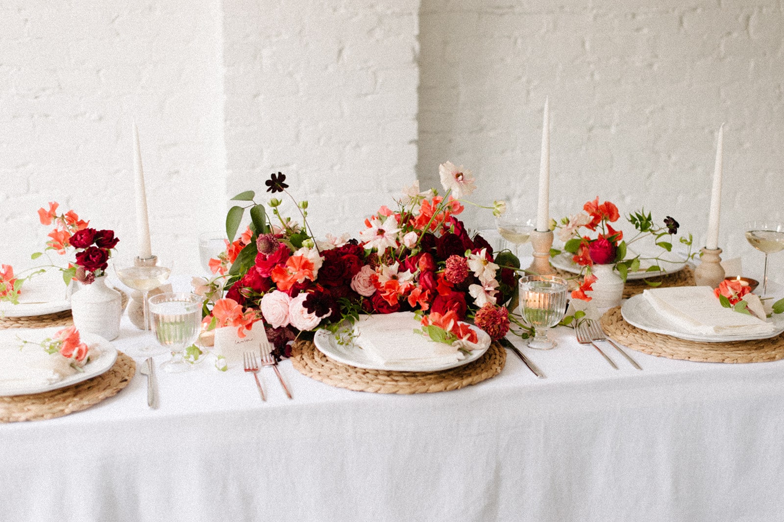 red and pink floral for valentines day tabletop by anthera floral