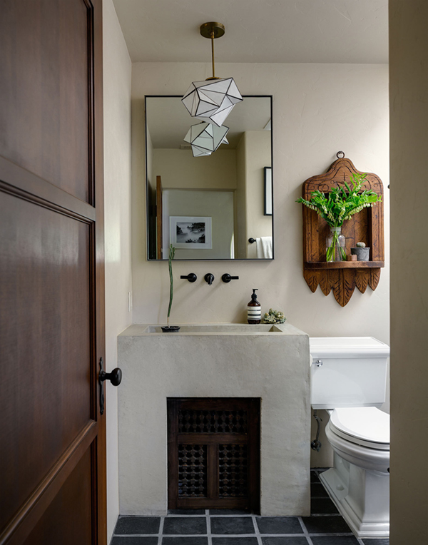 a hacienda style home boasts this beautiful poured concrete sink with a modern pendant | via coco+kelley