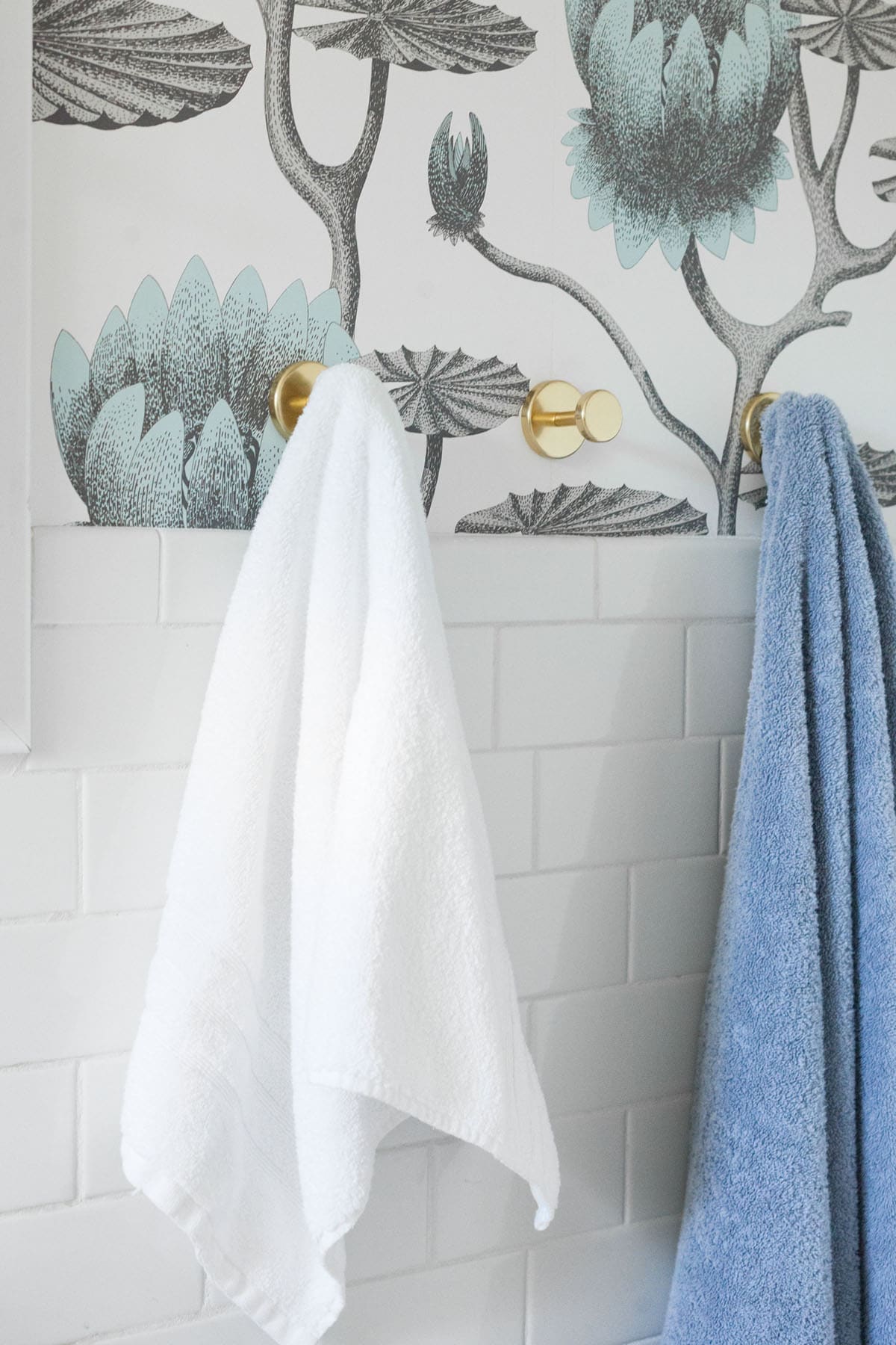 small hooks provide ample hanging space for towels in this bathroom makeover | coco kelley-1