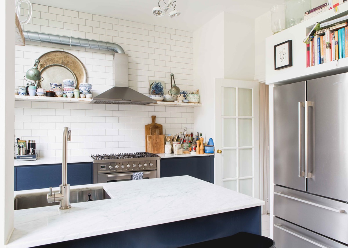 small kitchen with open shelving and dark blue cabinets | house tour on coco kelley