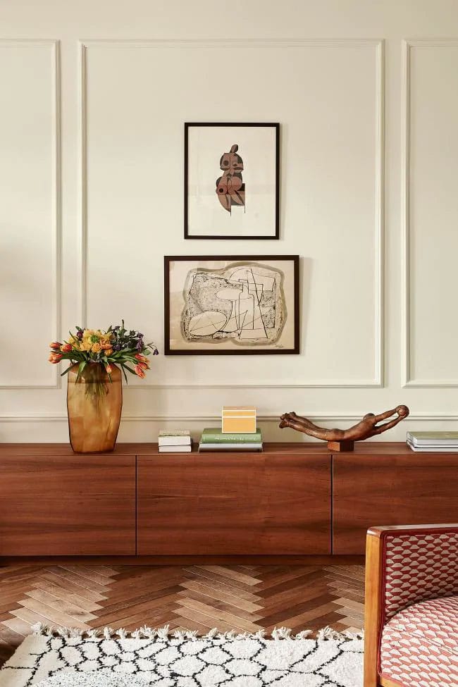 stacked artwork and low midcentury credenza | polish prewar apartment tour on coco kelley