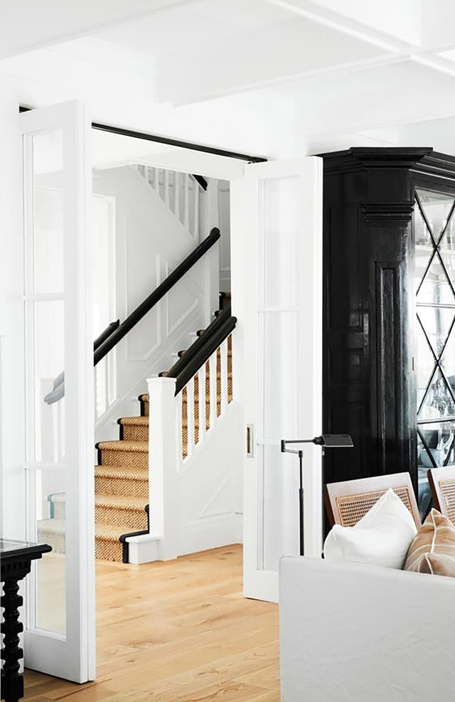 stairwell in black and white with sisal jute rug runner | coco kelley