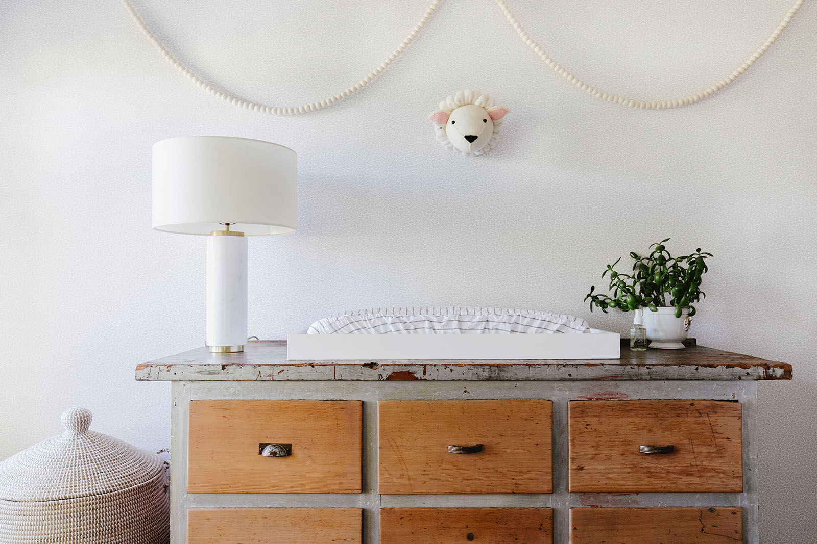 sweet modern cottage nursery with lamb and pom pom garland | coco kelley