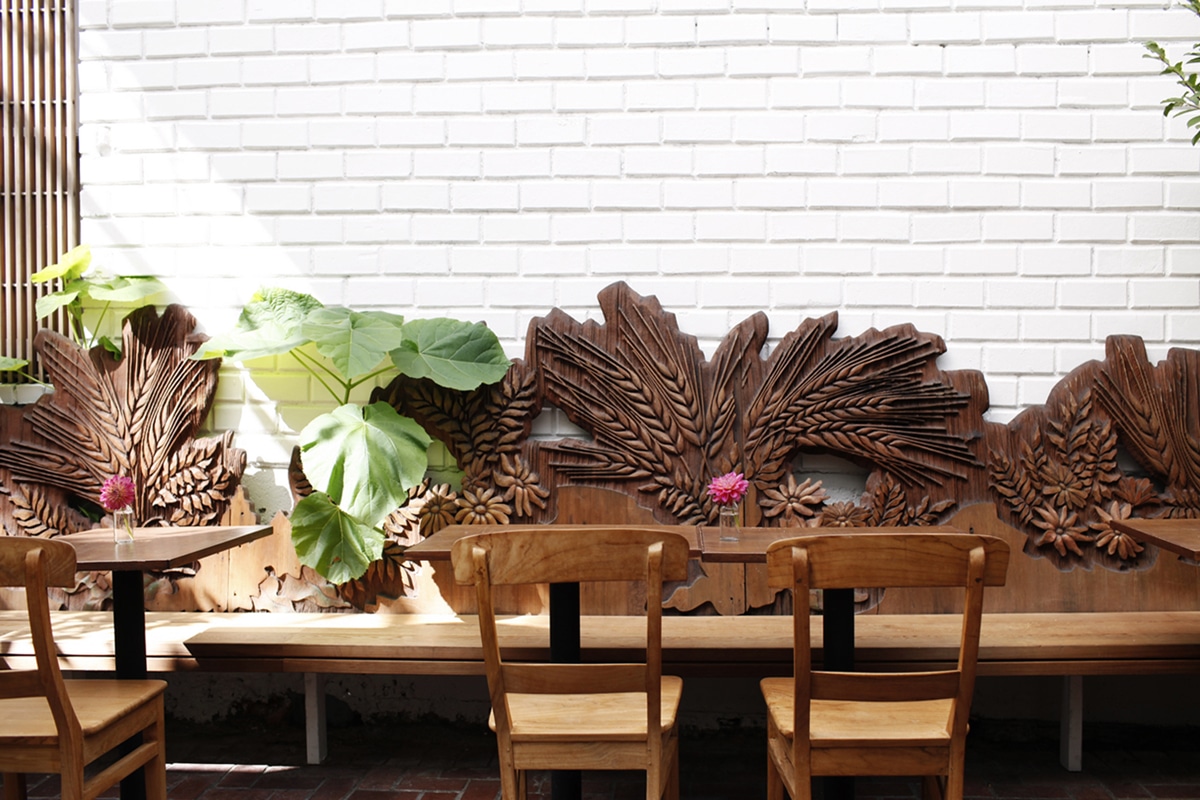 the vintage wood banquettes at bar vacilando | seattle restaurant design coco kelley