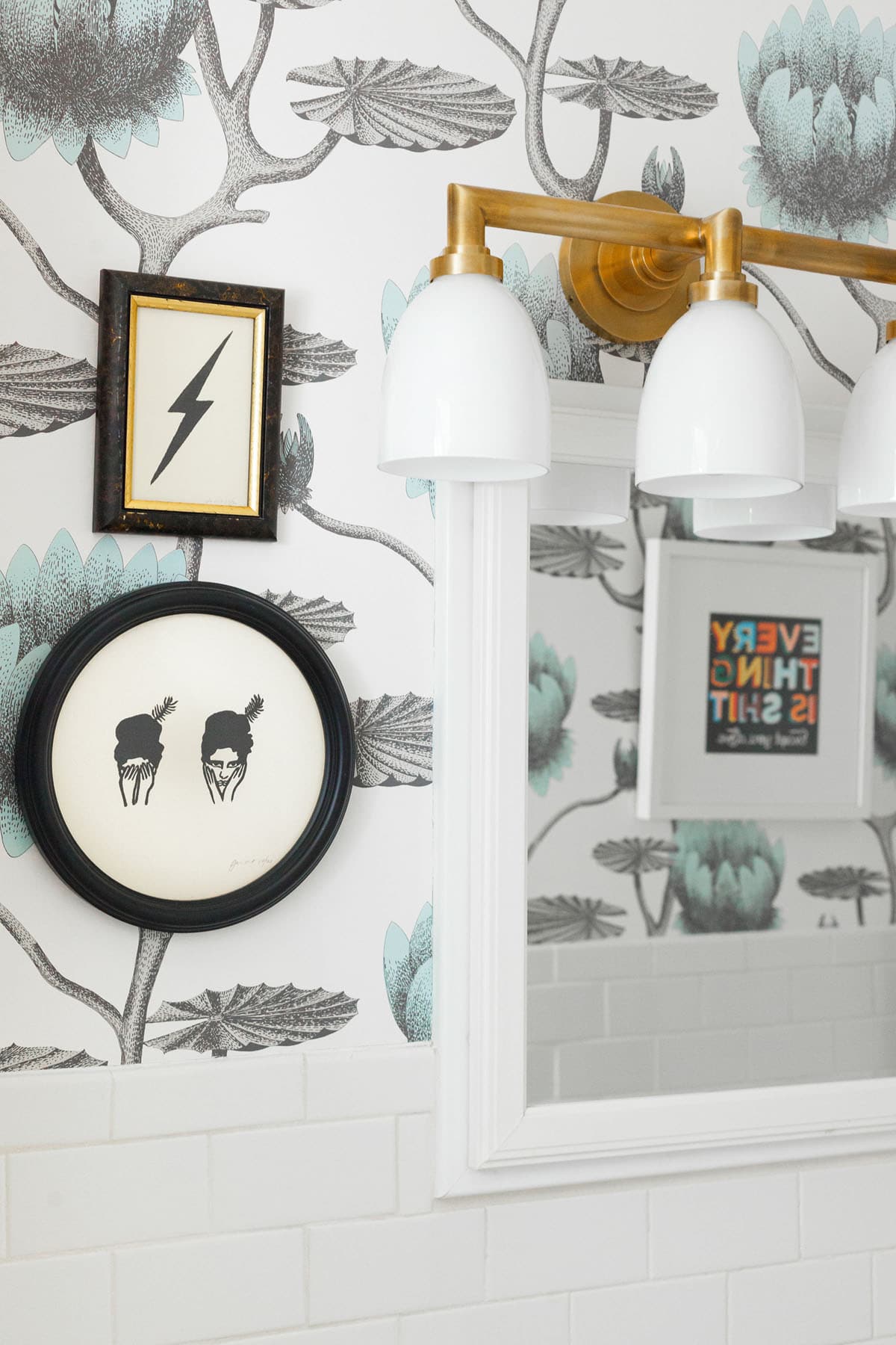 this mini bathroom boasts fun artwork and wallpaper | makeover on coco kelley