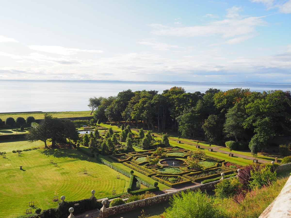  view-of-the-gardens-and-the-sea-from-Dunrobin-Castle-in-Scotland-tour-on-coco-kelley