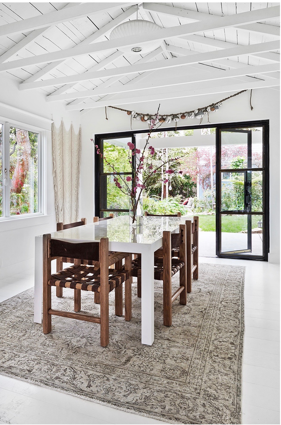 vintage dining chairs and modern white table in this airy dining room | california style house tour on coco kelley