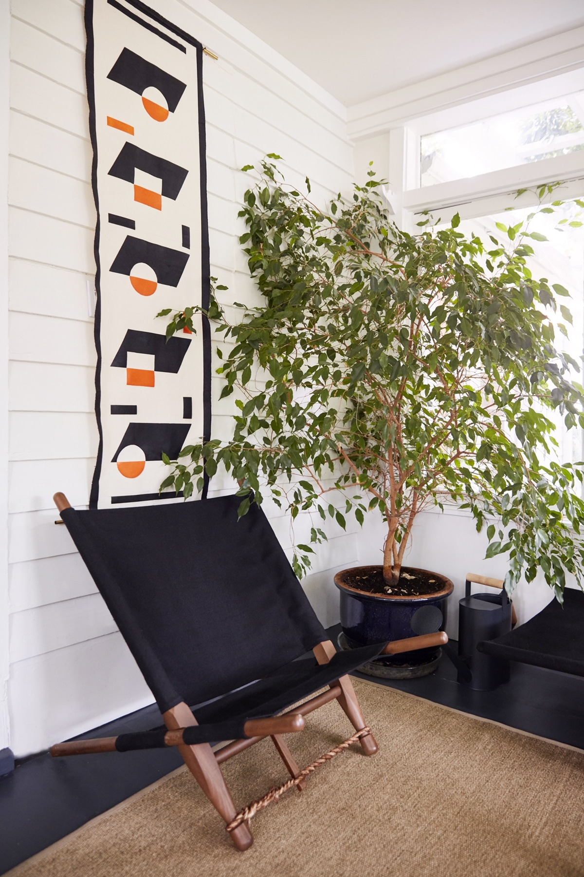 vintage organic furnishings and wall hanging in the sun porch | modern shaker house tour designed by cs valentin on coco kelley