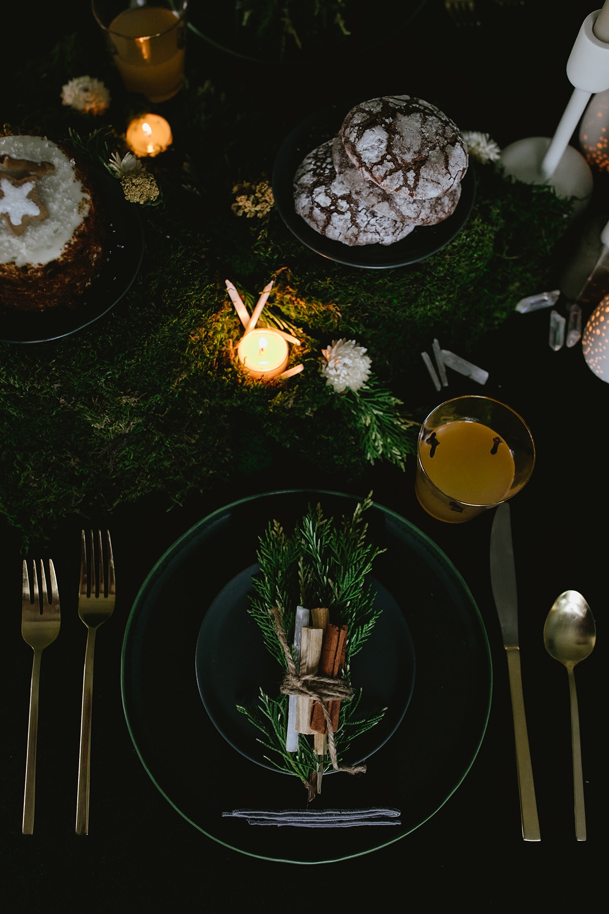 votives tucked into moss as a part of our winter solstice tabletop