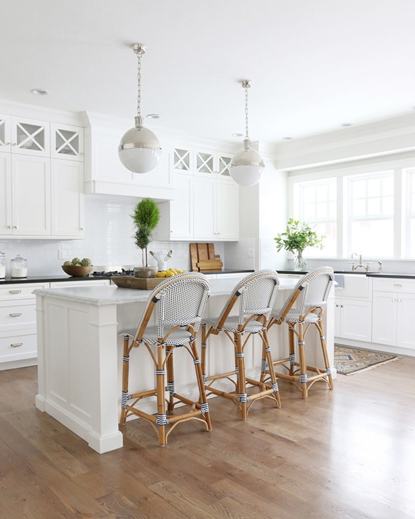 french cafe woven bar stools in classic all white kitchen | via coco kelley